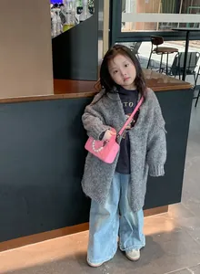 Pink quilted crossbody bag with pearls styled on a stylish kids' outfit street look