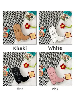 Detail of four stylish boot-shaped cross-body bags in khaki, white, black and pink colors
