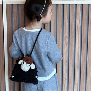 Cute black crochet sheep crossbody bag for children featuring a handmade knit design