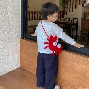Cute red crochet crab shoulder bag for kids featuring a unique knitted cross-eye design