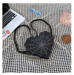 Détail du sac gothique en forme de cœur avec broderie toile d'araignée blanche sur cuir