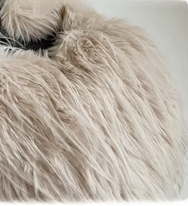Gros plan sur la texture en fausse fourrure beige du grand sac bandoulière en peluche