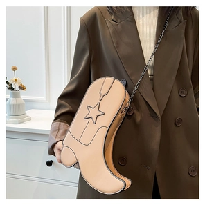 Detail of creative boot-shaped crossbody bag in apricot with star charm and chain strap