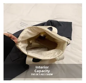Macro view of white canvas tote bag interior with large capacity and zippered pocket