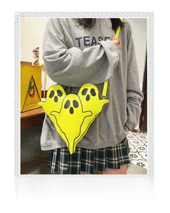 Detail view of funny yellow ghost shoulder bag showing 3D tiered cartoon character design