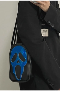 Close-up of holographic blue Ghostface mask design on a black leather crossbody bag