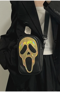 Close-up of holographic Scream Ghostface mask detail on a black leather crossbody bag