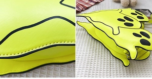 Macro shot of neon yellow ghost monster bag with textured leather and stitched seams