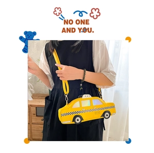 Model wearing a yellow New York taxi car-shaped crossbody bag with a black dress