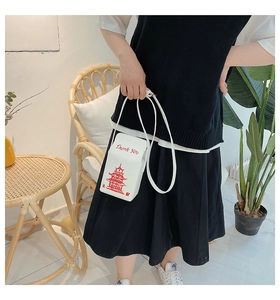 Detail of white Chinese takeout box style crossbody bag with red Thank You print