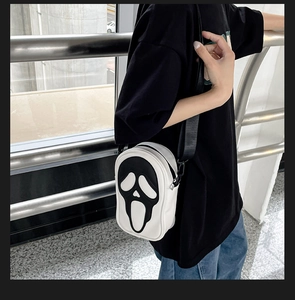 Detailed view of Scream Ghostface pattern on a black and white crossbody small square bag