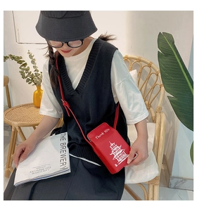 Detail of red crossbody phone bag featuring white Thank You text and tower illustration