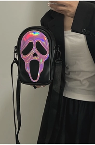 Detail of the holographic Scream ghostface mask on a black crossbody streetwear bag