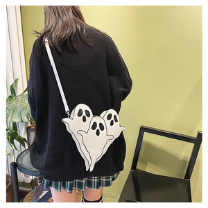 Quirky ghost-shaped white leather crossbody bag worn by a model in a creative style