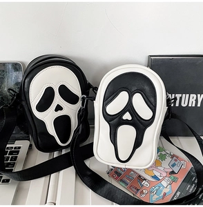 Detailed view of Scream Ghostface themed crossbody bag on office desk setting