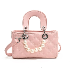 Pink quilted crossbody bag for kids with pearl handle and leather strap in minimalist style