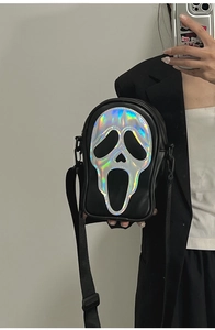 Detail of laser reflective Ghostface patch on a black PU leather crossbody bag