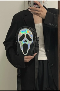 Detail of laser holographic Ghostface mask pattern on black crossbody bag for women