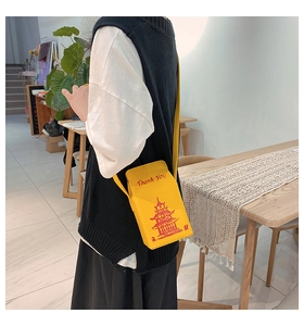 Detail showing creative yellow PU leather crossbody bag designed like a Chinese takeout box