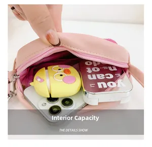 Detail view of the pink mini crossbody bag showing internal capacity with a smartphone