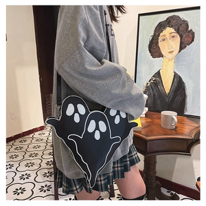 Detail of creative ghost-shaped crossbody bag featuring unique cartoon eyes and leather strap