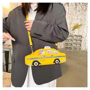 Detailed view of yellow NYC taxi shaped crossbody bag featuring laser material windows