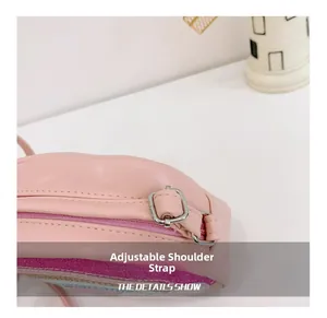Detail showing adjustable pink shoulder strap with metal buckle for kids crossbody bag