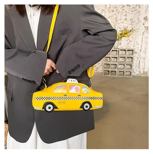 Detail showing creative yellow taxi shaped crossbody bag with NYC taxi print and checkered patterns