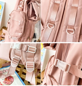 Detail of pink backpack featuring padded straps, white buckles and small detachable pouch