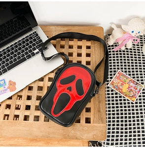 Detailed view of the Ghostface mask crossbody bag with red laser finish and leather texture