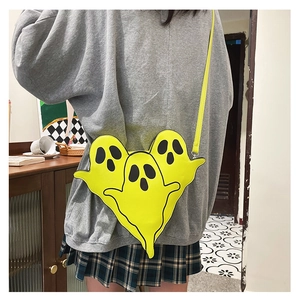 Detailed back view of a model wearing the yellow ghost-shaped crossbody bag