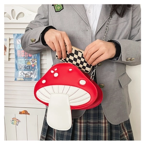Detail view of the cute red and white mushroom shoulder bag showing interior storage space