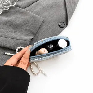 Detailed capacity showcase of denim mini bag with pearl chain and sequins
