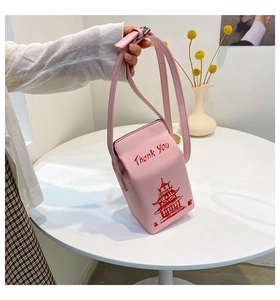 Close-up of pink Chinese takeout box crossbody bag with Thank You print and chain strap
