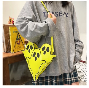 Detailed view of creative yellow ghost-shaped crossbody bag with adjustable PU strap