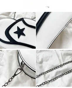 Detail view of white PU leather crossbody bag with black star appliques and metal chain