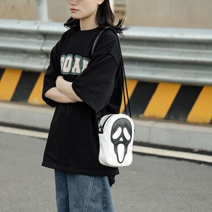 Mini white crossbody bag with Ghostface mask pattern and adjustable black strap for street style