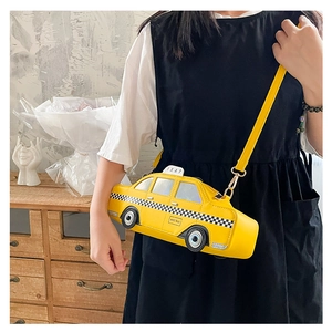 Detailed shot of yellow NYC Taxi shaped crossbody bag with checkerboard pattern and strap
