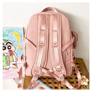 Detail of pink backpack featuring ergonomic S-shaped straps and secure chest buckle