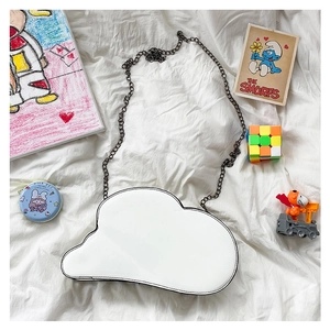 Detailed top view of a creative white cloud-shaped shoulder bag with a dark metal chain