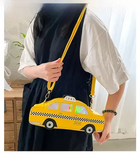 Detail of yellow taxi shaped crossbody bag with NYC TAXI text and checkerboard trim
