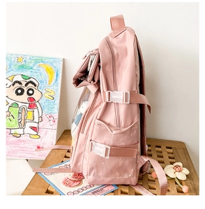Detailed side view of pink backpack featuring a large transparent window for decorations
