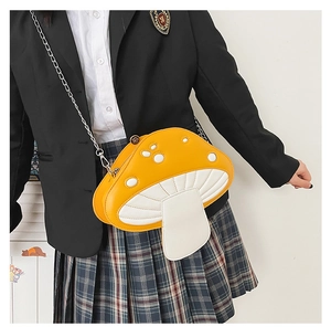 Detailed close-up of cartoon mushroom shoulder bag with metallic chain and PU texture