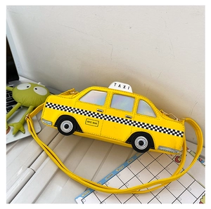 Close-up of a yellow taxi-shaped crossbody bag featuring checkered patterns and taxi sign