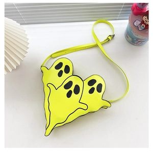 Flat lay of heart-shaped ghost crossbody bag in neon yellow on a white surface