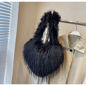 Détail d'un sac à main noir en fausse fourrure en forme de cœur avec une texture douce et chic