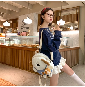 Detail of white plush dog backpack with lamb wool texture and cute blue overalls accent