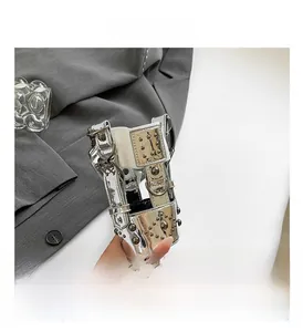 Detailed macro view of silver metallic strap with studs and D-ring buckle