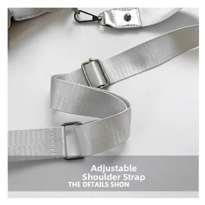 Detail view of adjustable silver silk shoulder strap with polished metal hardware buckles