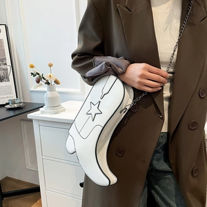 Unique white cowboy boot shaped crossbody bag with star applique and silver chain strap